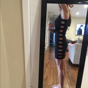 Medium black body con dress with side cutouts.